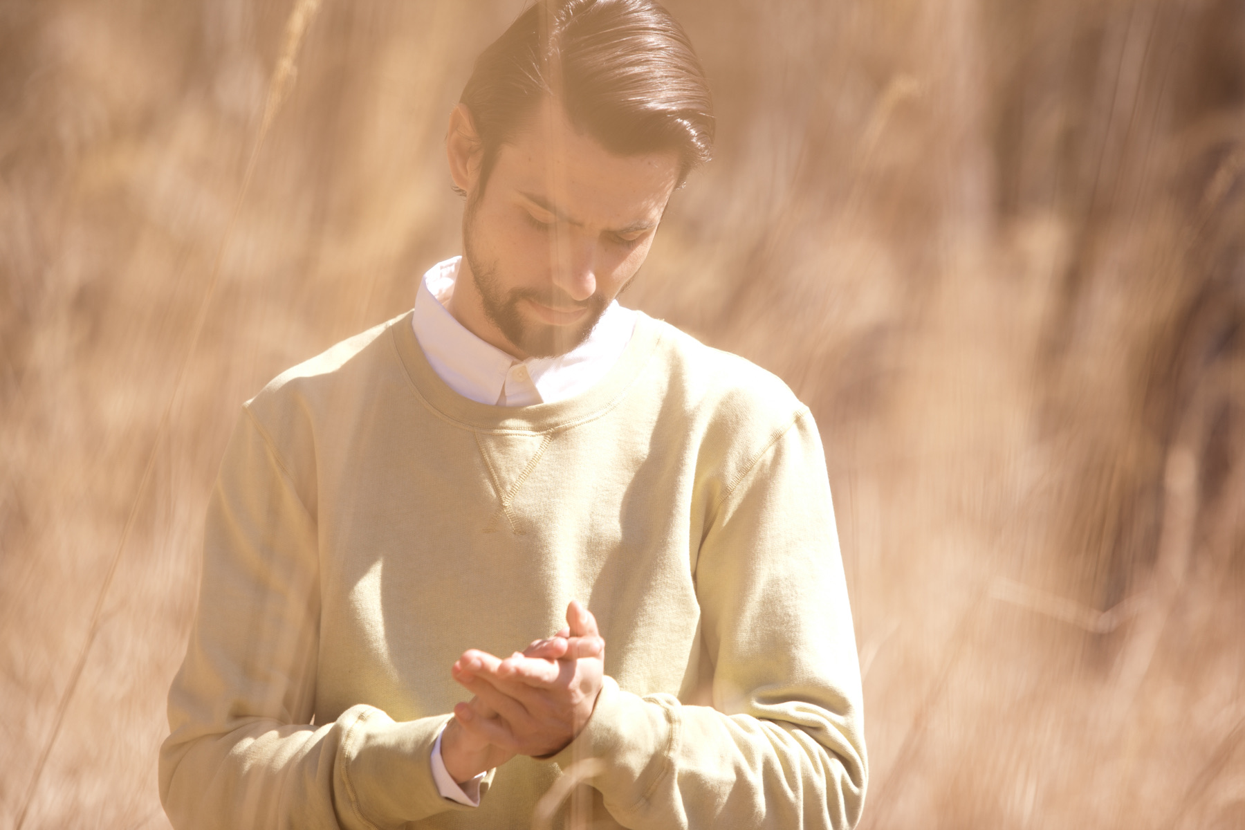 Layered sweatshirt and white shirt in warm light